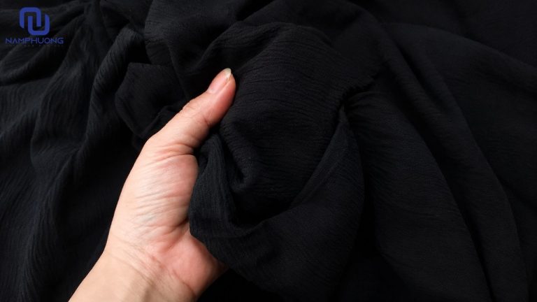 Vải thô đũi đen có độ rủ tự nhiên, giúp trang phục có vẻ ngoài nhẹ nhàng